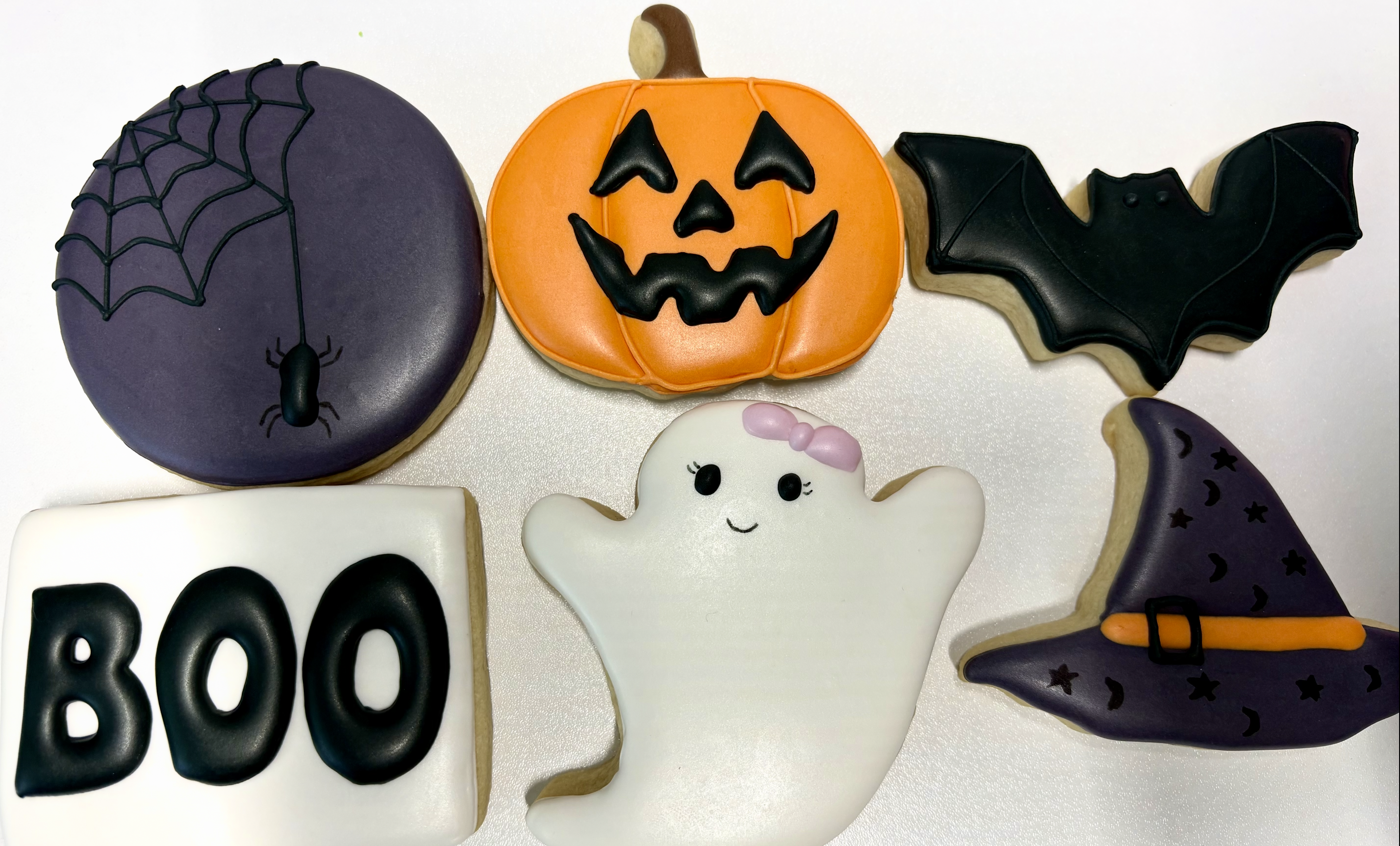 Halloween-themed decorated cookies for a dozen box